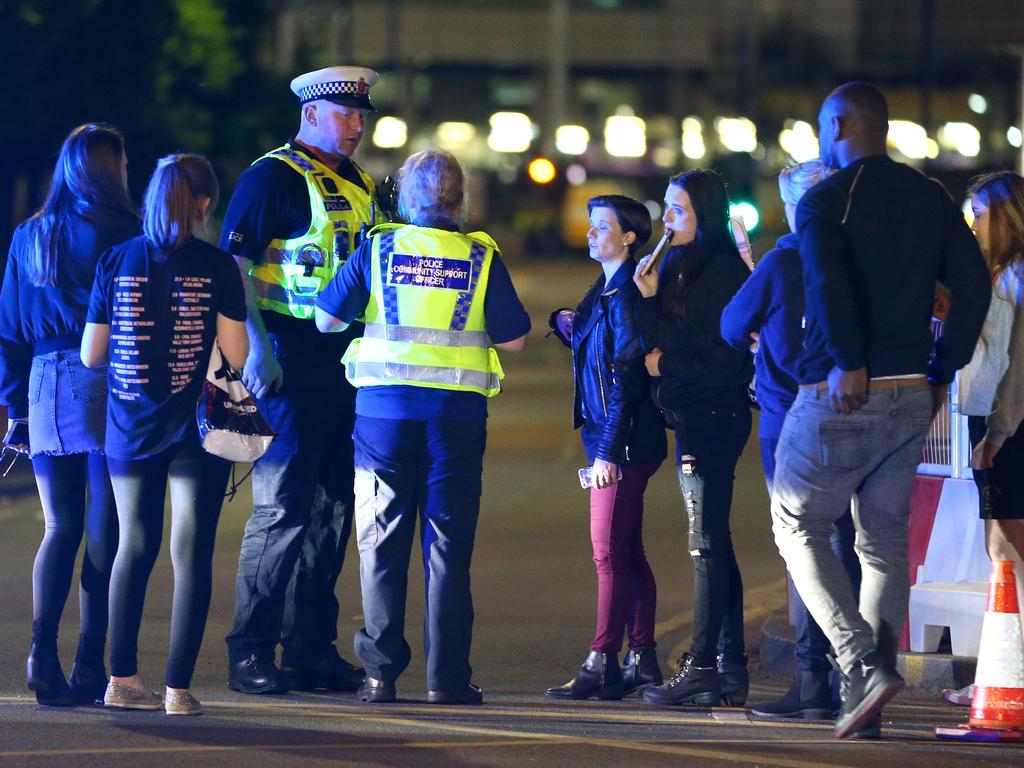 Police and fans close to the Manchester Arena after reports of an explosion at the venue during an Ariana Grande concert. Picture: Getty