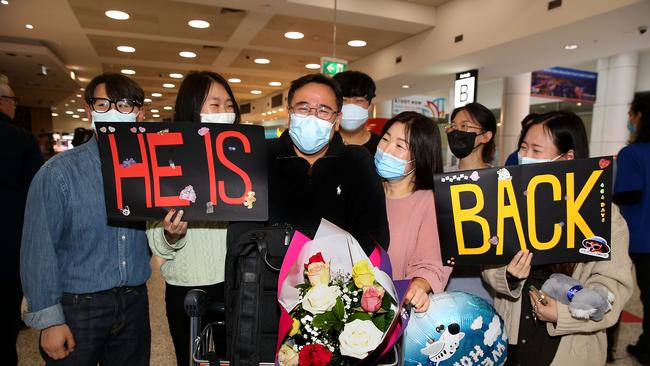 John Yun is greeted by family and friends. He was among Sydney Airport’s first tourist arrivals from Singapore on Sunday. Picture: Jane Dempster