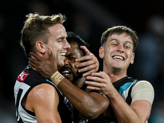 ADELAIDE, AUSTRALIA - APRIL 05:   Willie Rioli of the Power   celebrates a goal with Jackson Mead and  Zak Butters of the Power  during the round four AFL match between Port Adelaide Power and Essendon Bombers at Adelaide Oval, on April 05, 2024, in Adelaide, Australia. (Photo by Mark Brake/Getty Images)