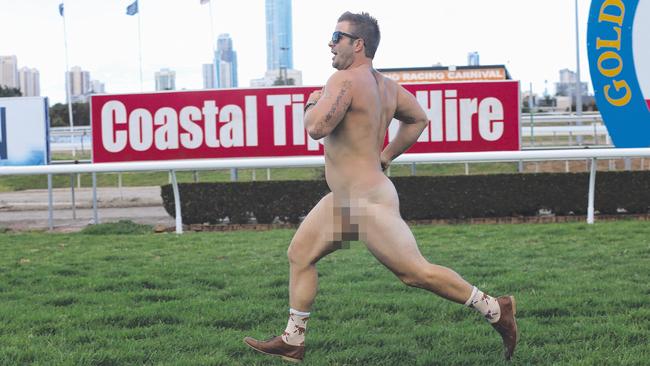 A streaker races across the track during the Pink Ribbon Cup held at the Gold Coast Turf Club. Picture: Regi Varghese