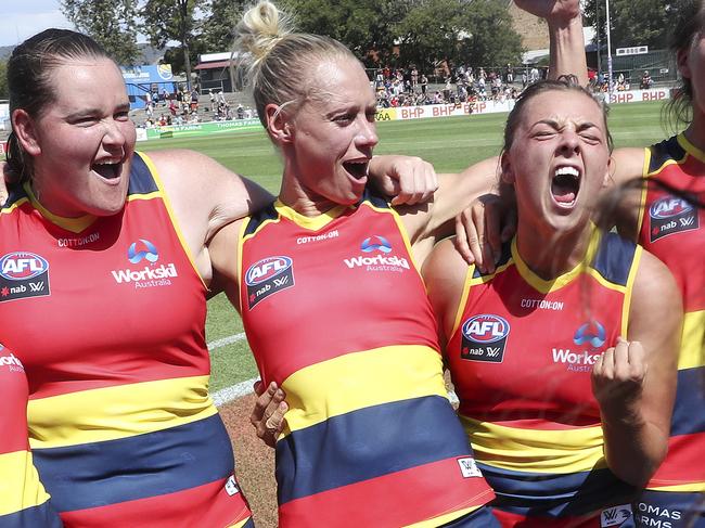 Crows players Sarah Perkins, Erin Phillips and Ebony Marinoff singing the club song after being Geelong by 29 points at Norwood Oval on Sunday, February 17. Picture SARAH REED