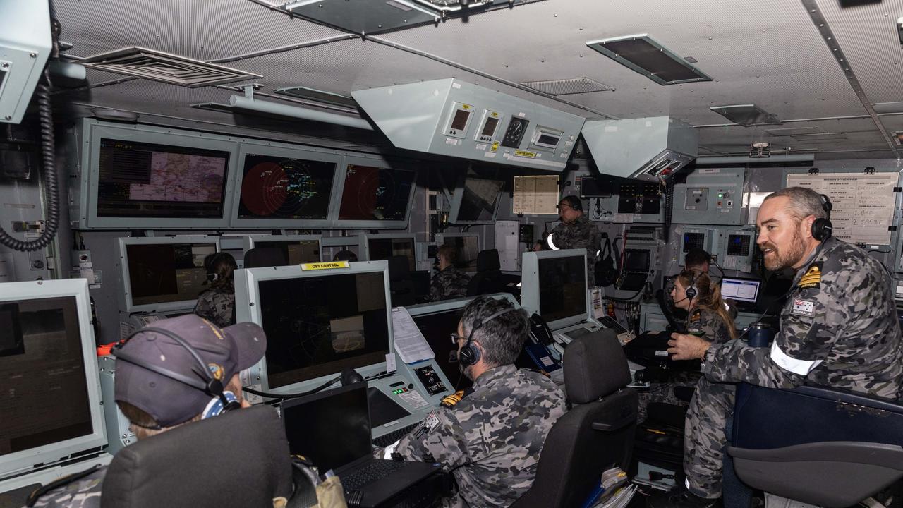 Commanding Officer HMAS Warramunga Commander Dylan Phillips CSM observes the ships actions in the operations room. Picture: Department of Defence.