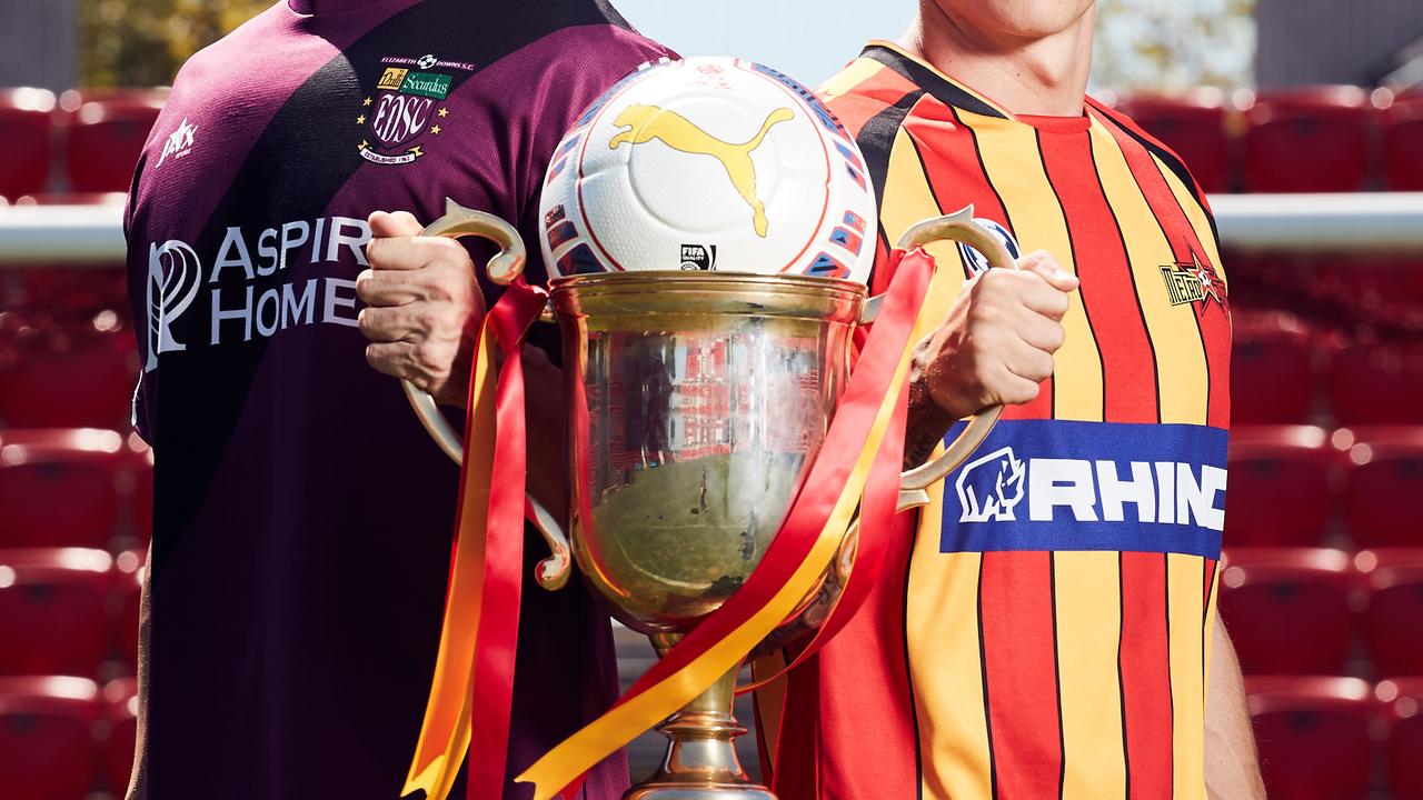 Matt Watson from Elizabeth Downs and Liam Wooding from Metrostars pose for a picture with the FFA Cup at Coopers Stadium in Hindmarsh, where local amateur soccer clubs have been nominated to play in the league, Friday, Feb. 23, 2018. (AAP Image/MATT LOXTON)