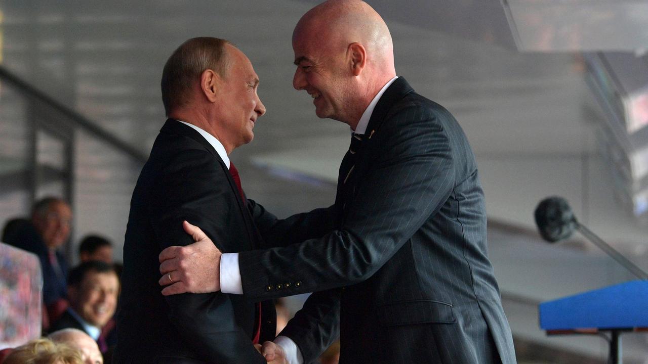 Russian president Vladimir Putin and FIFA President Gianni Infantino shake hands during the opening ceremony.