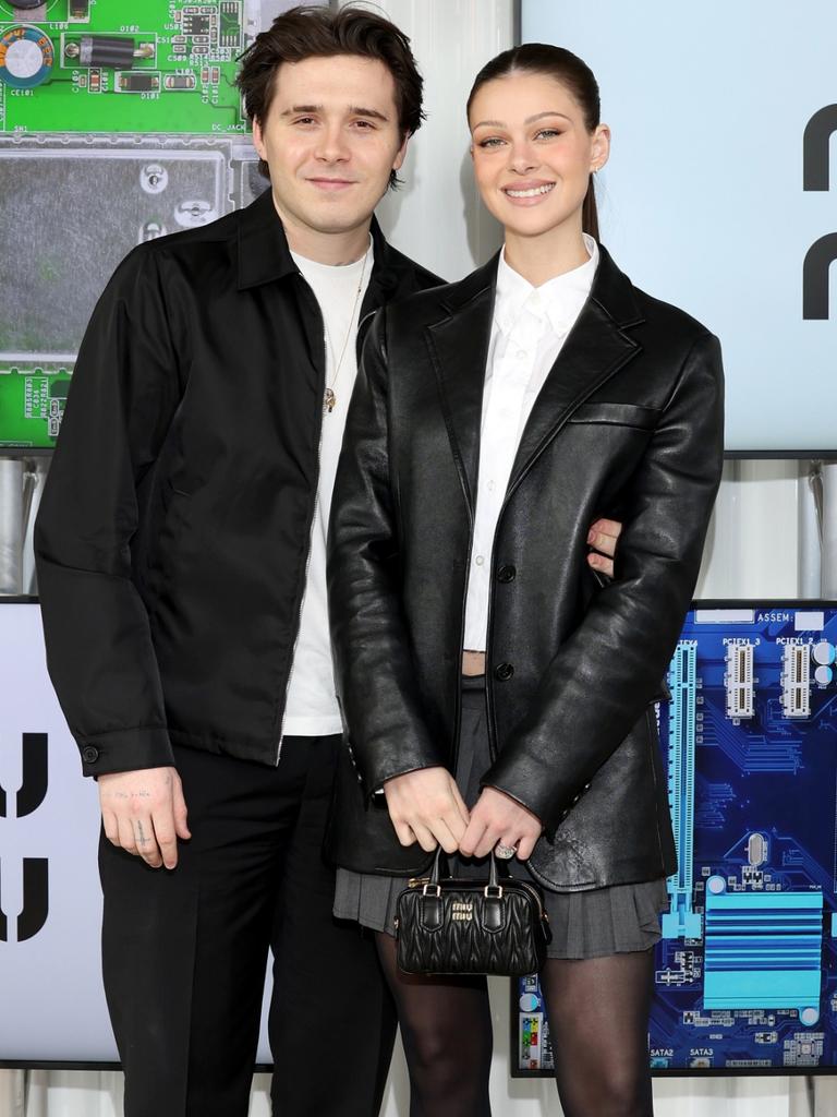 Brooklyn Beckham and Nicola in matching looks. Picture: Arnold Jerocki/Getty Images for Miu Miu