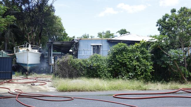 Queensland Fire and Emergency Services firefighters attend a large house fire at Christensen Street, Machans Beach. The blaze was contained quickly, with 6 fire trucks attending the emergency. No one was injured. Picture: Brendan Radke