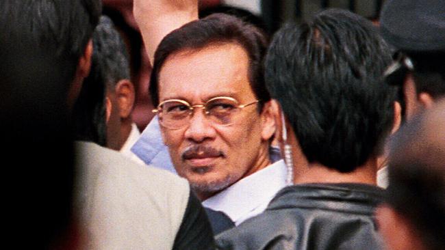 A battered Anwar under arrest in 1998.