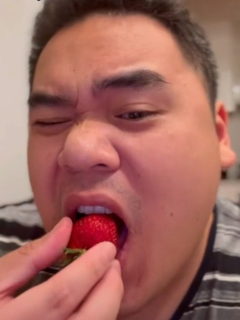 This is him really enjoying the batter after dipping a strawberry in it. Picture: TikTok/adrianwidjy