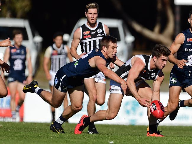 Joel Cross of South Adelaide tackles Will Snelling of Port Adelaide. Picture: Tom Huntley