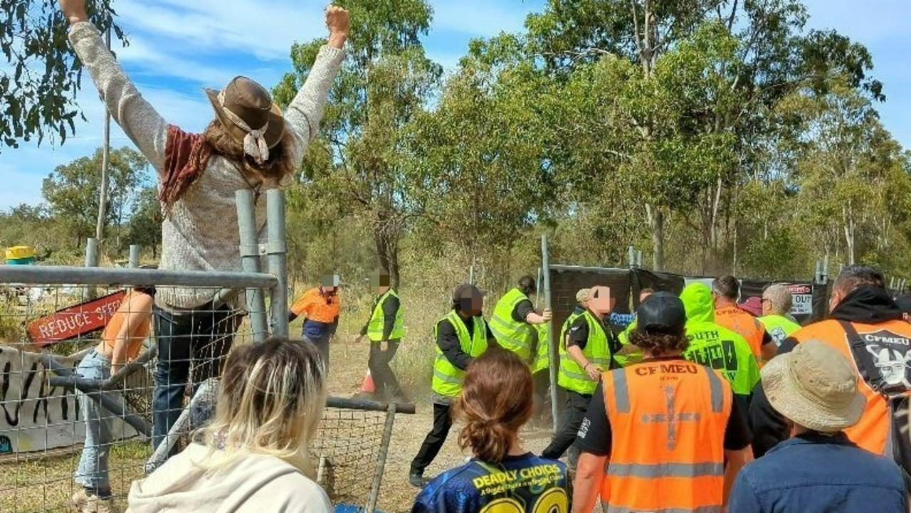 Protesters climbed onto and pushed down fences at a Deebing Creek site after its First Nations occupants were evicted this morning. Picture: Nicola McNamara