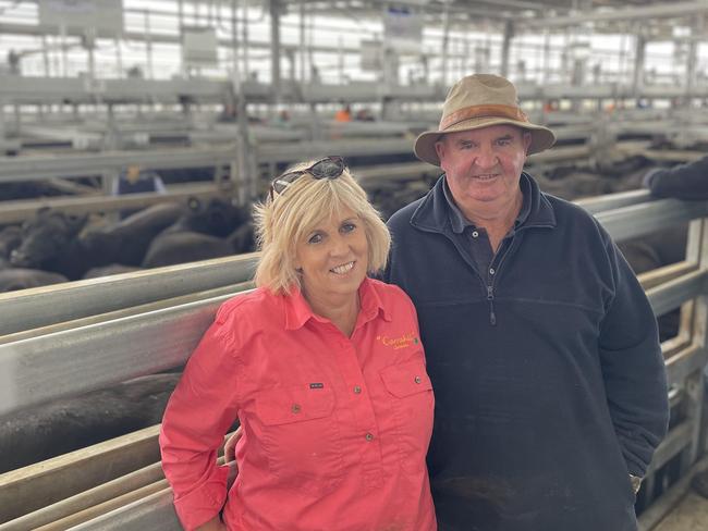 Marty and Lou Gleeson from Carrahil at Clarendon in front of their huge pen of 70 Angus steers which returned $2850 or 614c/kg.