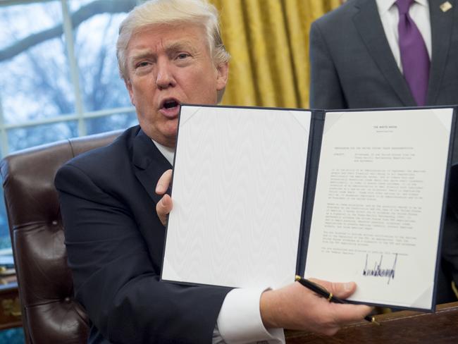 President Trump proudly signed an executive order withdrawing the US from the TPP on his first working day in office. Picture: AFP Photo / Saul Loeb