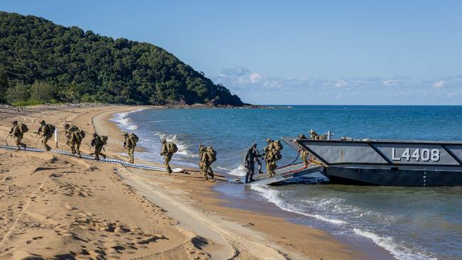 Soldiers, sailors and aviators from the Australian Amphibious Force disembark an LHD Landing Craft at Cowley Beach, QLD, as part of the Wet and Dry Environmental Rehearsals. Picture: Captain Annie Richardson