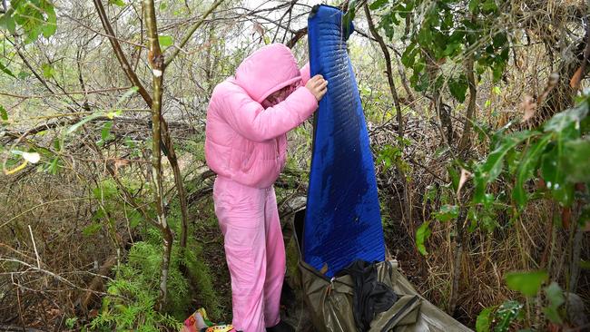 Emma Lacey tries to dry out her swag after a cold and rainy night. Picture: Patrick Woods.