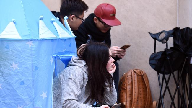 Customers looking less than excited as they wait in line for the iPhone 7.