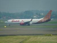 Jakarta, Indonesia, August 19, 2024A Batik Air plane prepares for takeoff in bad weather conditions with smoke in the air at Soekarno-Hatta International Airport.