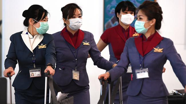 Face masks could become a standard part of cabin crew uniforms in a post-pandemic world. Picture: AAP