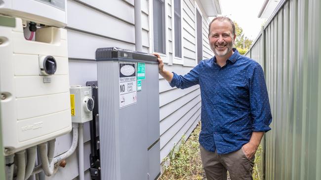 Jonathan Prendergast displaying his battery that is used to power his home in Como during peak times. Picture: Ted Lamb