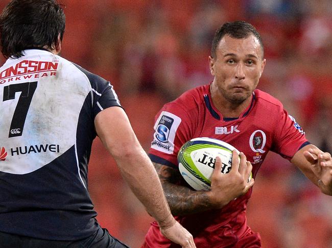 BRISBANE, AUSTRALIA - MARCH 27: Quade Cooper of the Reds looks to take on the defence during the round seven Super Rugby match between the Reds and the Lions at Suncorp Stadium on March 27, 2015 in Brisbane, Australia. (Photo by Bradley Kanaris/Getty Images)