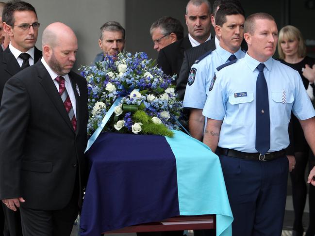 Pallbearers carry the coffin of Detective Senior Constable Damian Leeding during his funeral service at Gold Coast Convention Centre, Tuesday, June 7, 2011. Leeding was shot by armed robbers at the Pacific Pines Tavern on the Gold Coast on May 29 and died in hospital last Wednesday. (AAP Image/Adam Head) NO ARCHIVING