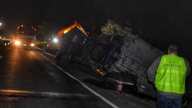 An Austrans employee attends the scene of the truck crash. Picture: Peta McEachern