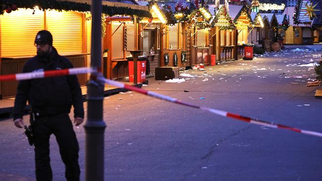 A policeman walks through the shuttered Christmas market. Picture: Getty