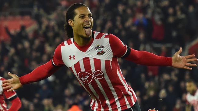 (FILES) This file photo taken on December 28, 2016 shows Southampton's Dutch defender Virgil van Dijk (C) celebrates scoring the opening goal during the English Premier League football match between Southampton and Tottenham Hotspur at St Mary's Stadium in Southampton, southern England on December 28, 2016. Liverpool have signed Southampton's Virgil van Dijk, a statement on the club's website said on December 27, 2017, for a reported £75 million ($100 million, 84 million euros) in a deal that will make him the world's most expensive defender. / AFP PHOTO / Glyn KIRK / RESTRICTED TO EDITORIAL USE. No use with unauthorized audio, video, data, fixture lists, club/league logos or 'live' services. Online in-match use limited to 75 images, no video emulation. No use in betting, games or single club/league/player publications.  /