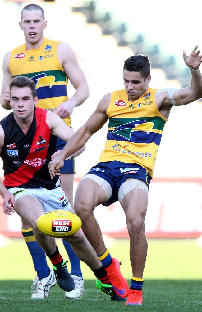 Eagles star Jared Petrenko gets his kick away ahead of West’s William Snelling. Photo: Sarah Reed.