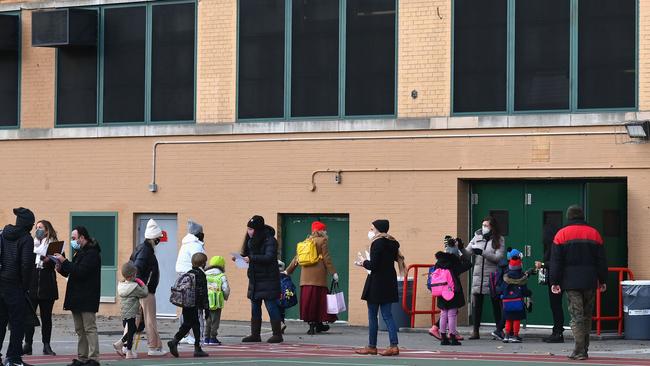 Children check in as they arrive for class on the first day of school reopening on December 7, 2020. Many schools in the US remain closed because of the pandemic. Picture: Angela Weiss/AFP)