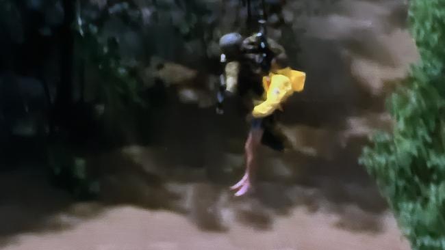 SKY TV frame grabs of a live rescue from the top of a in Lismore by the defence force - a third person is pictured being airlifted to a helicopter