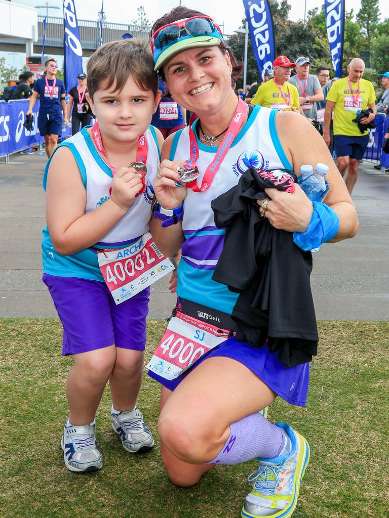 Archie Wood, 5, with his Aunty Sarah Jane Marshall from Brisbane pose for a photo at the end of the Gold Coast Airport Fun Run. Picture: Tim Marsden.