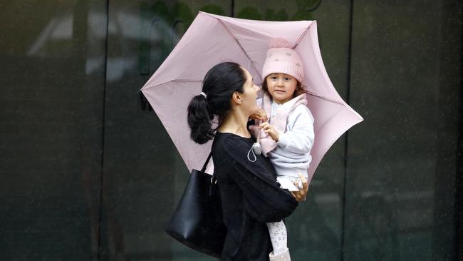 BRISBANE, AUSTRALIA - NewsWire Photos DECMBER 1, 2022: Persistent rain and temperatures as low as 15 degrees had people in Brisbane bring out the brollies with the first day of summer resembling more of a winter feel. Picture: NCA NewsWire/Tertius Pickard