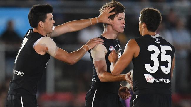 (L-R) Matthew Kennedy, Paddy Dow and Ed Curnow of the Blues react after Dow kicked a goal (AAP Image/Julian Smith)