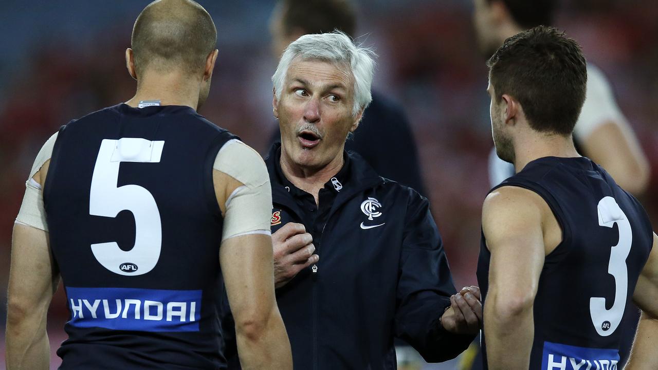 Mick Malthouse talks with Chris Judd and Marc Murphy in 2013.