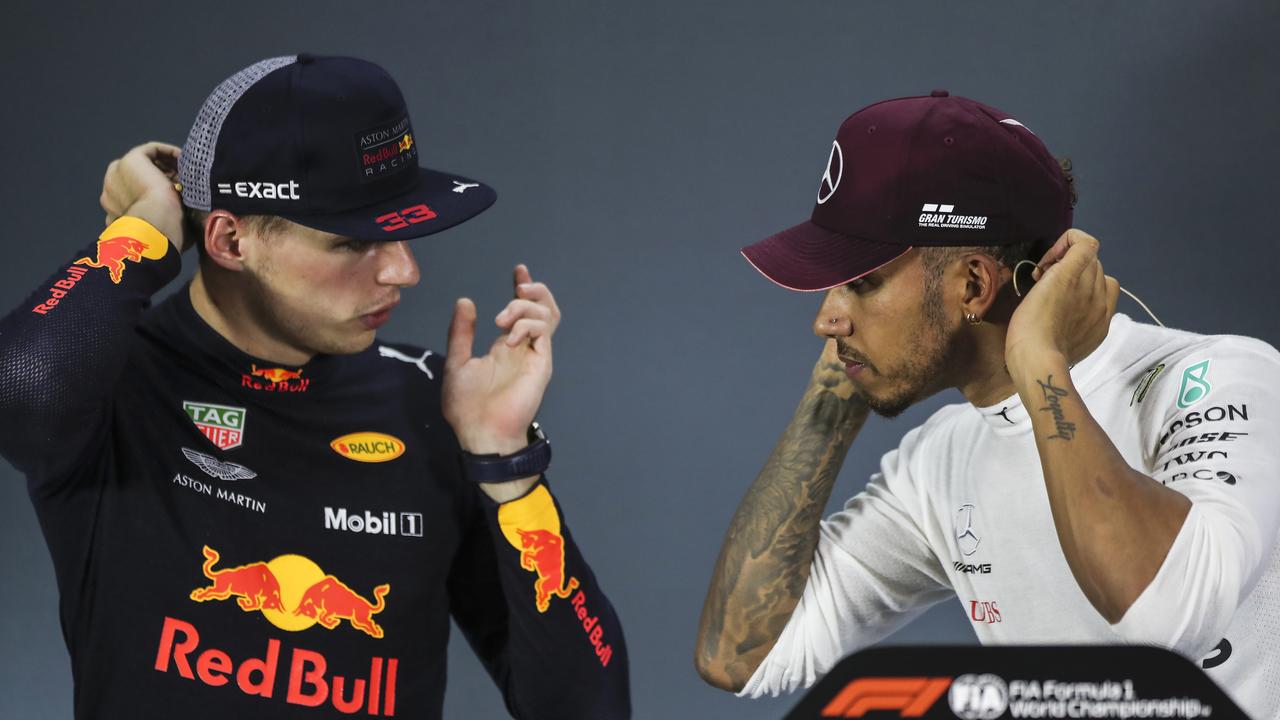 Red Bull driver Max Verstappen speaks to Mercedes driver Lewis Hamilton during a press conference. (AP Photo/Yong Teck Lim)