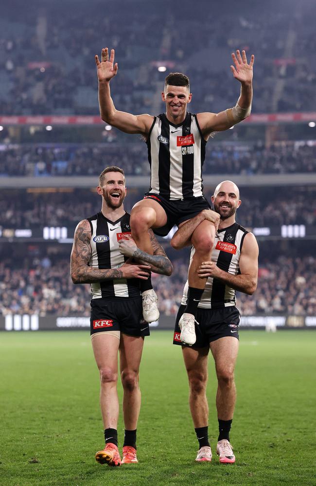 Scott Pendlebury chaired off after his 400th game by Jeremy Howe and Steele Sidebottom. Picture: Mark Stewart