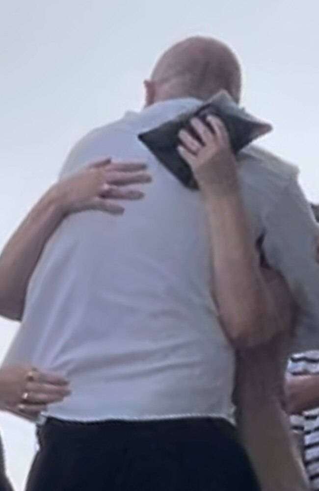 Aaron Leonard Holland hugging his family outside Beenleigh Magistrate Court.