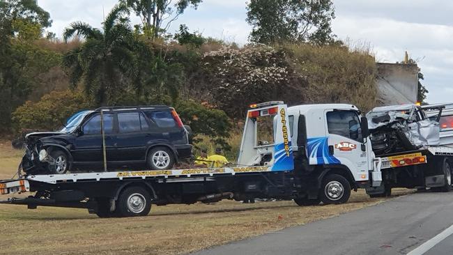 A tow truck transports a car involved in a fatal crash north of Townsville on Sunday.