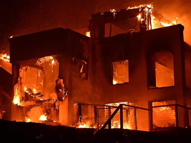 A house is engulfed in flames as the Palisades Fire burns along Pacific Coast Highway in Malibu, California, on January 8, 2025. At least five people have been killed in wildfires rampaging around Los Angeles, officials said on January 8, with firefighters overwhelmed by the speed and ferocity of multiple blazes -- including in Hollywood. (Photo by AGUSTIN PAULLIER / AFP)