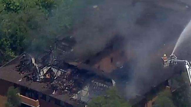 Twelve firetrucks were battling a blaze that is tearing through an apartment block in Sydney's Merrylands. Picture: Seven News