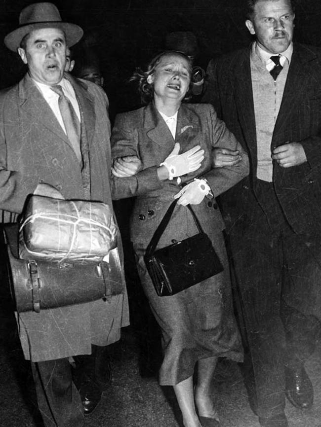 Mrs Petrov being escorted by two armed Russian diplomatic couriers across the tarmac at Sydney Airport. Picture: AAP