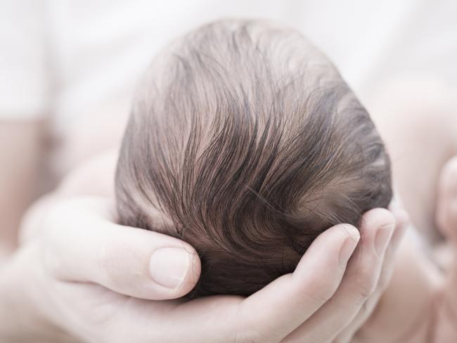 Newborn baby in adult hands  Picture: istock