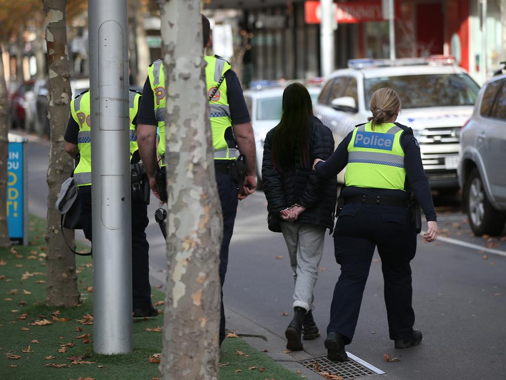 Police handcuff an alleged shoplifter in Little Malop Street Mall. Picture: Alison Wynd