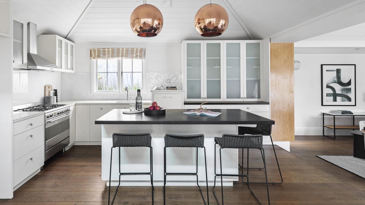 An island bench, soft-close drawers and stainless-steel ASKO and Smeg appliances in the kitchen.