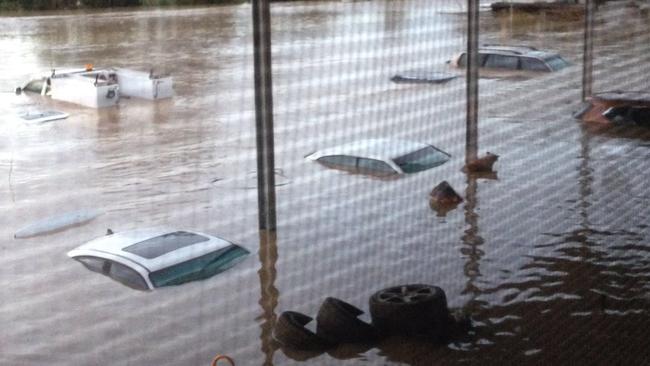 A house in Llandilo, next to South Creek, has been completely inundated as cars are almost covered. Picture: Avineet Sen