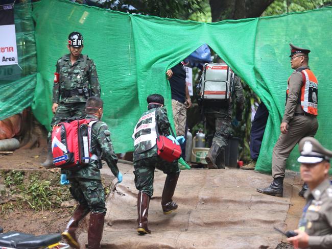 Thai military paramedics enter the Tham Luang cave area after divers evacuated some of the boys. Picture: AFP.