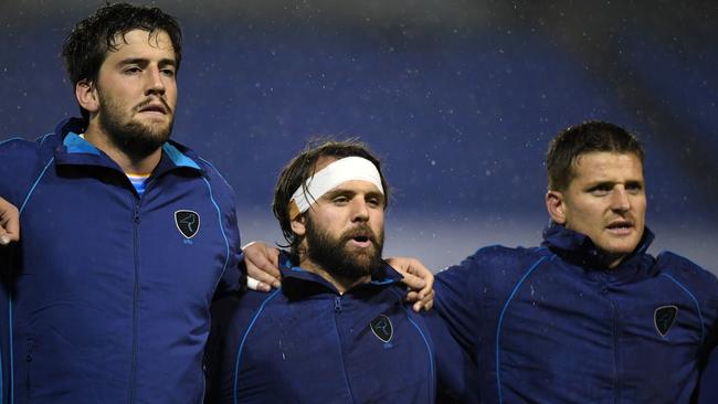 Ignacio Dotti, Federico Favaro and Leandro Leivas of Uruguay sing the national anthem.