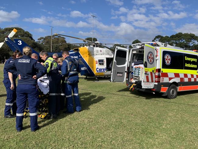 Paramedics work on the injured woman.