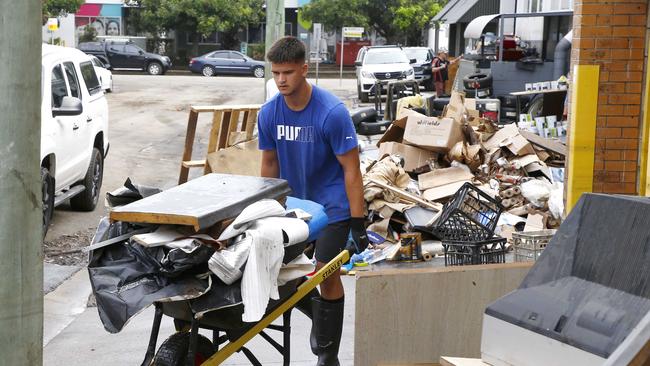 . A man cleaning up outside a business in Milton. Picture: NCA NewsWire/Tertius Pickard