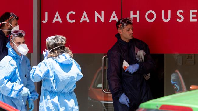 Workers dressed in full personal protective equipment were called in to clean a Darwin CBD building occupied by several Federal Government departments on Wednesday. Picture: Che Chorley